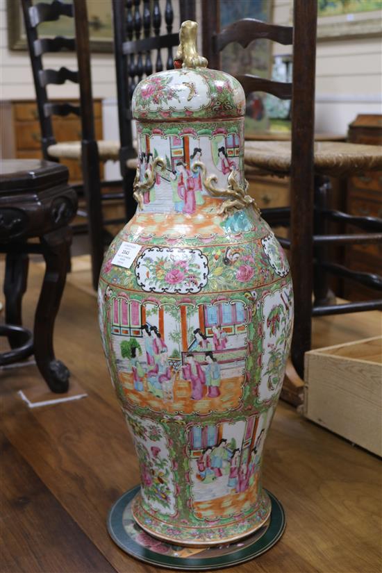 A pair of large 19th century Chinese famille rose vases and cover, 67.5cm high, repaired